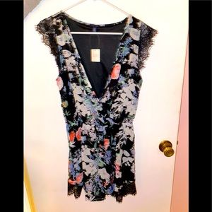 New with tags, black floral romper.